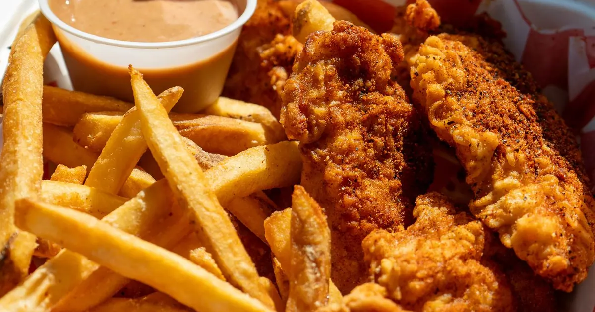 Takeout box of fried chicken tenders and fries with a dip - How to order from Wingstop: online, carryout and delivery
