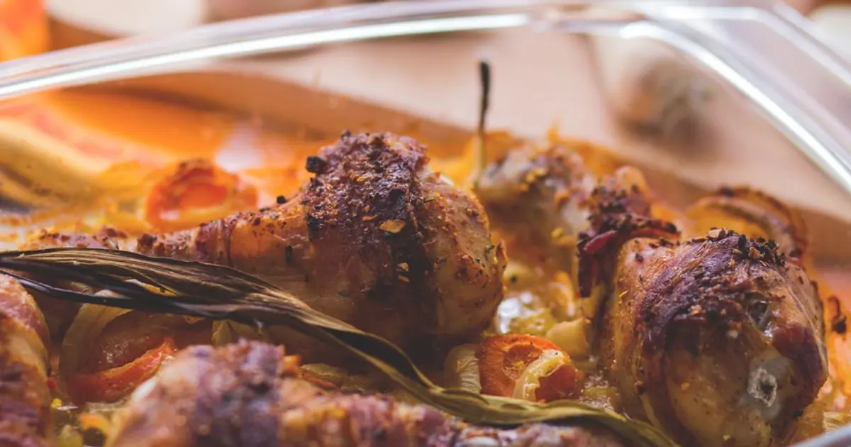 Roasted chicken pieces in a takeout container - How to reheat Wingstop wings (and store leftovers)