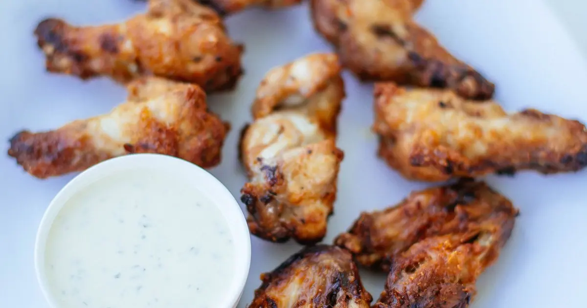 Glazed barbecue chicken wings on a plate - Sweet Wingstop flavors, and how much sugar they carry