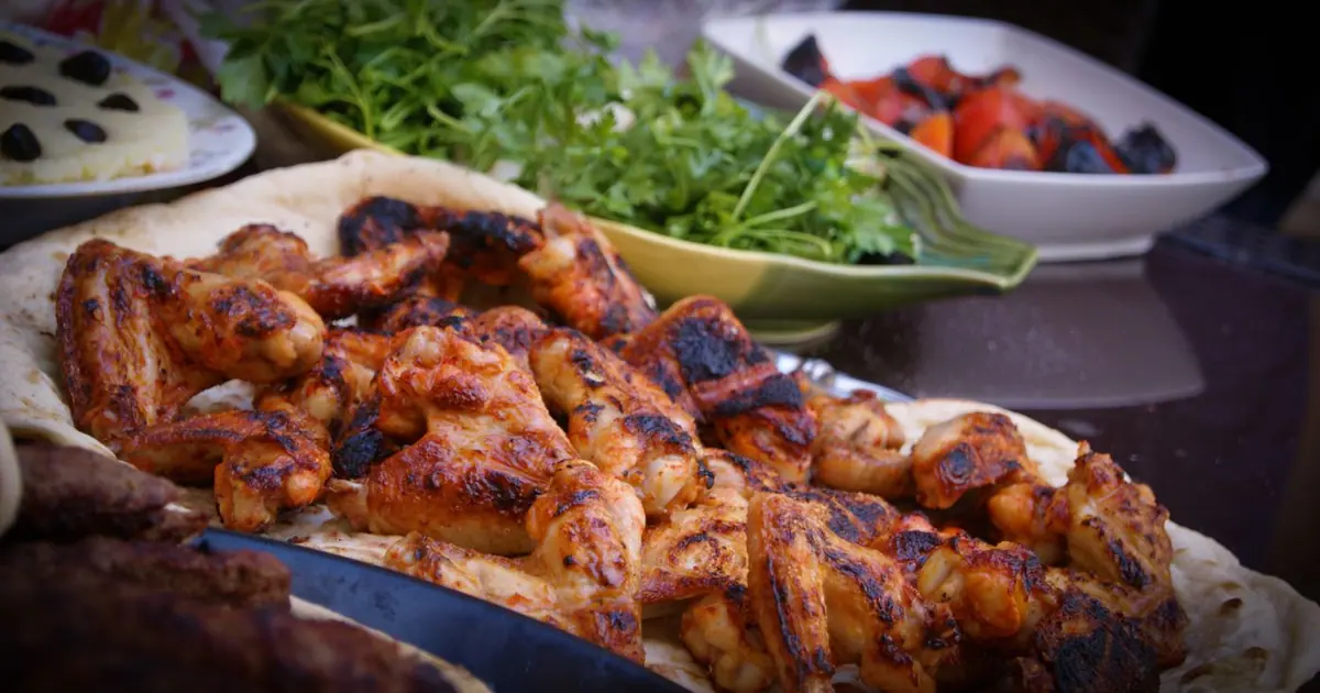 Seasoned grilled chicken wings on a platter - Is Wingstop gluten free? What the allergen guide says