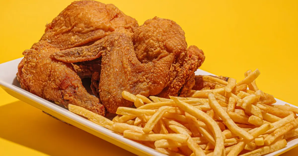 Fried chicken wings and french fries on a tray - How much do Wingstop wings cost? Prices by count